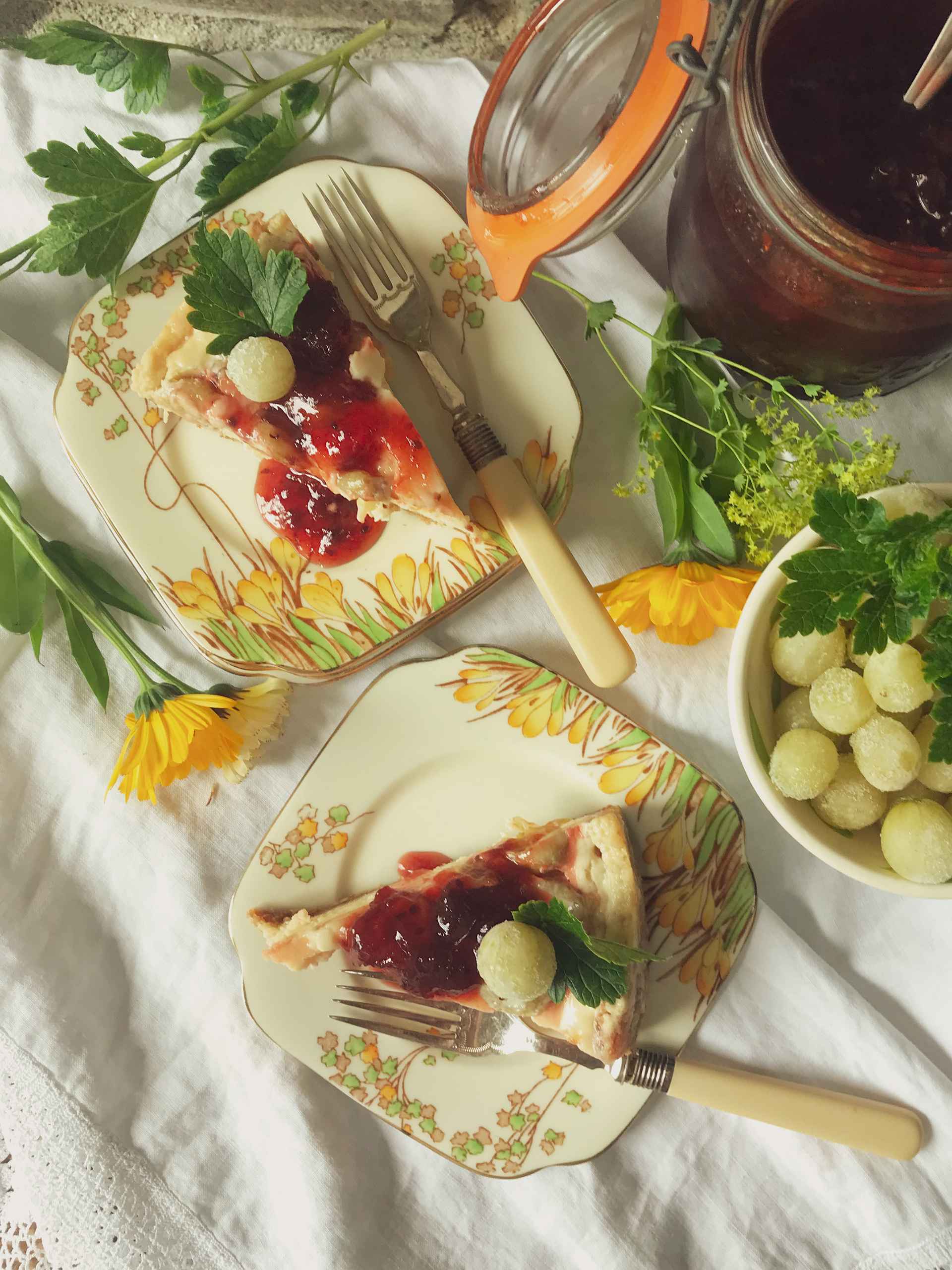 Two slices of Gooseberry and Ginger baked cheesecake on sideplates.