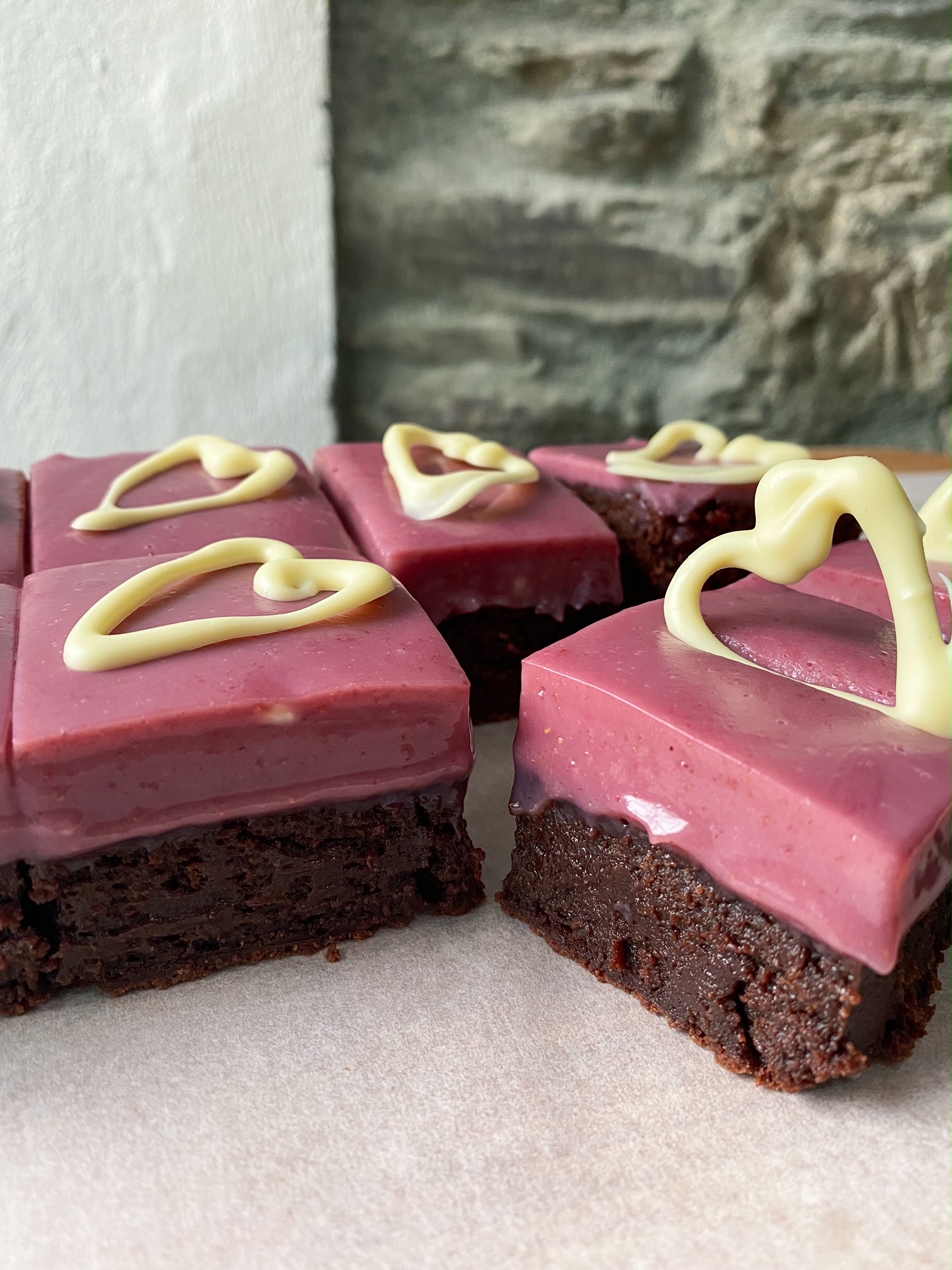 White Chocolate Berry Ganache Brownies with white chocolate hearts.