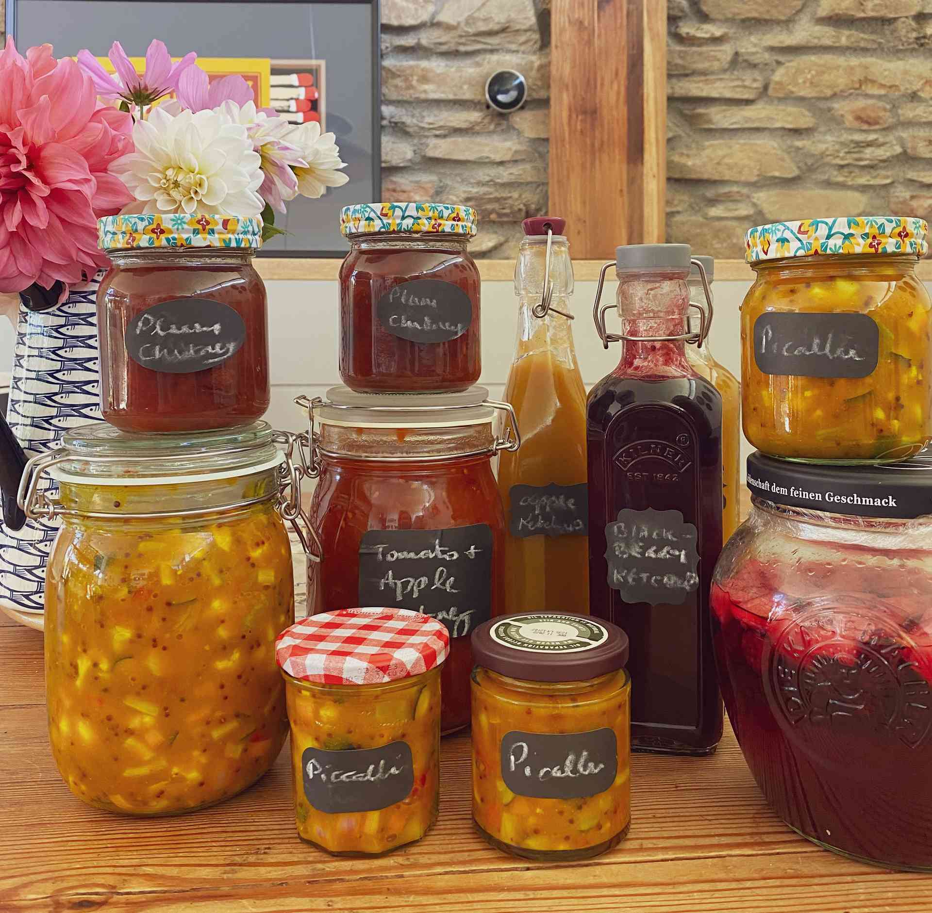 Ingredients and sauces in pots on a wooden table.