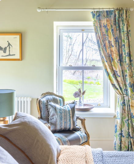 bed view to outside, flower curtains.