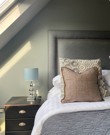 Bed close up view light shining inside through window.