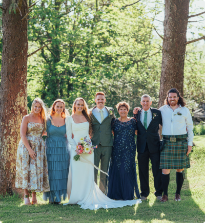 Family standing smiling.
