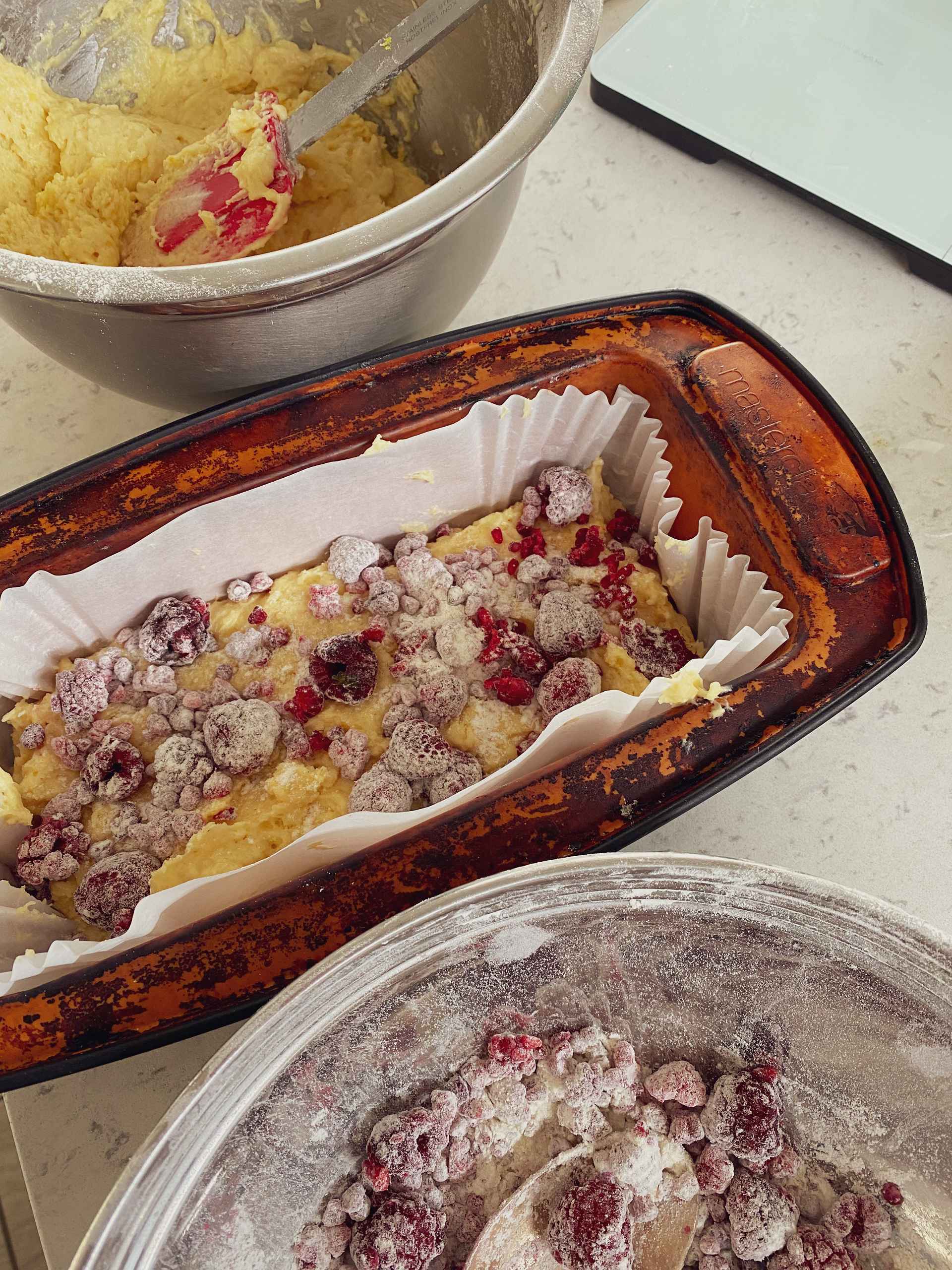 Zesty Raspberry Buttermilk Cake in a cake tin.