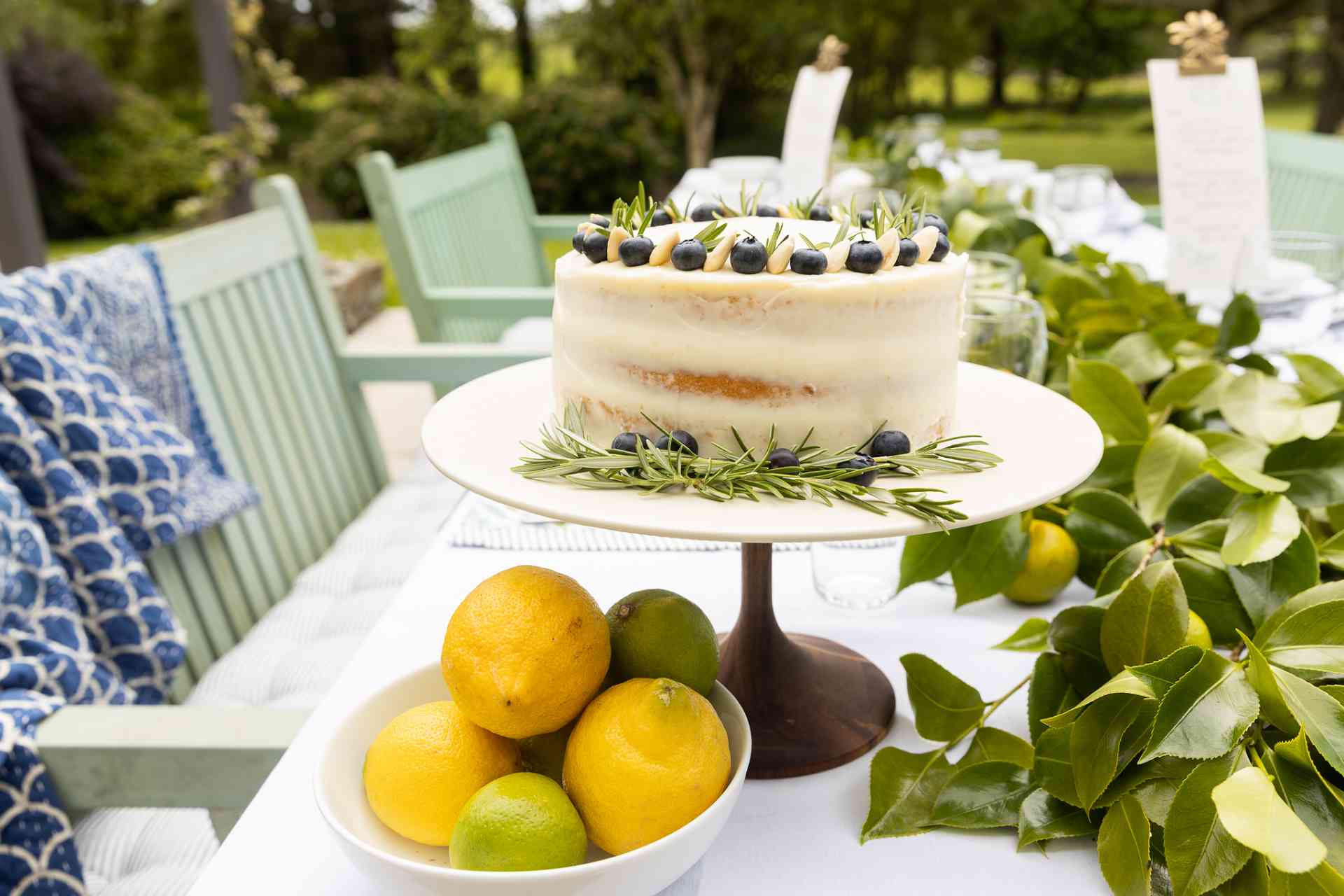 Lemon Curd Naked Sponge Cake on a plate on a table outside.