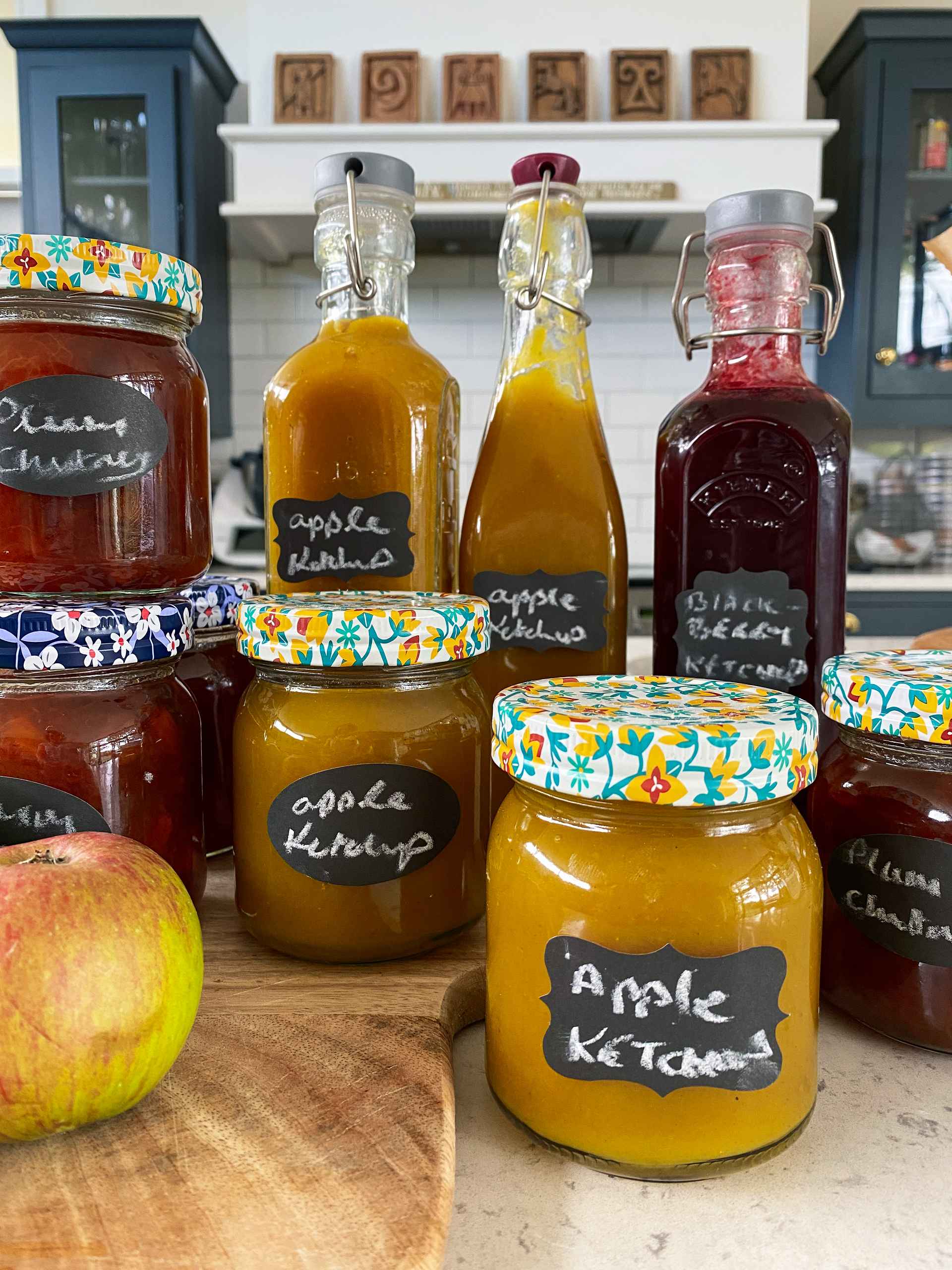 Ingredients and sauces in pots on a wooden table.