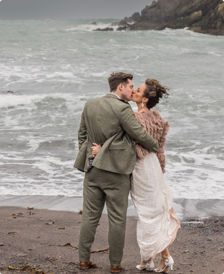 Wedding couple kissing near the sea.