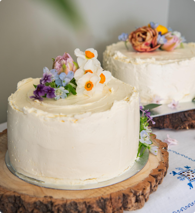 Dunowen white wedding cake with flowers on top.