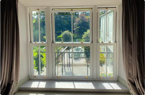 White window with brown curtains.