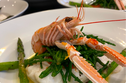 Prawn with asparagus on a plate.