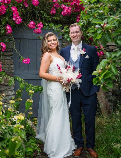 Wedding couple smiling and looking at the camera.