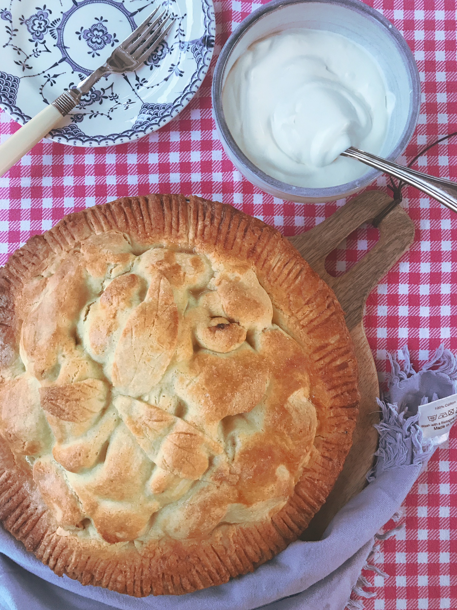 Apple pie on a wooden plate.