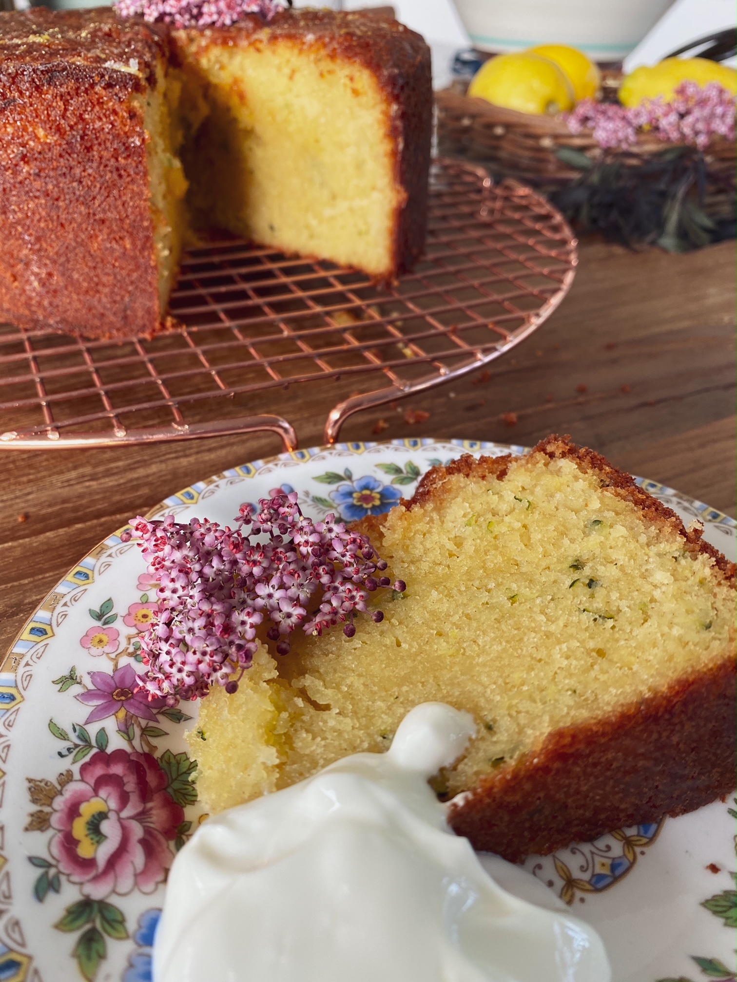 Elderflower, Lemon and Courgette Cake slice on a sideplate.