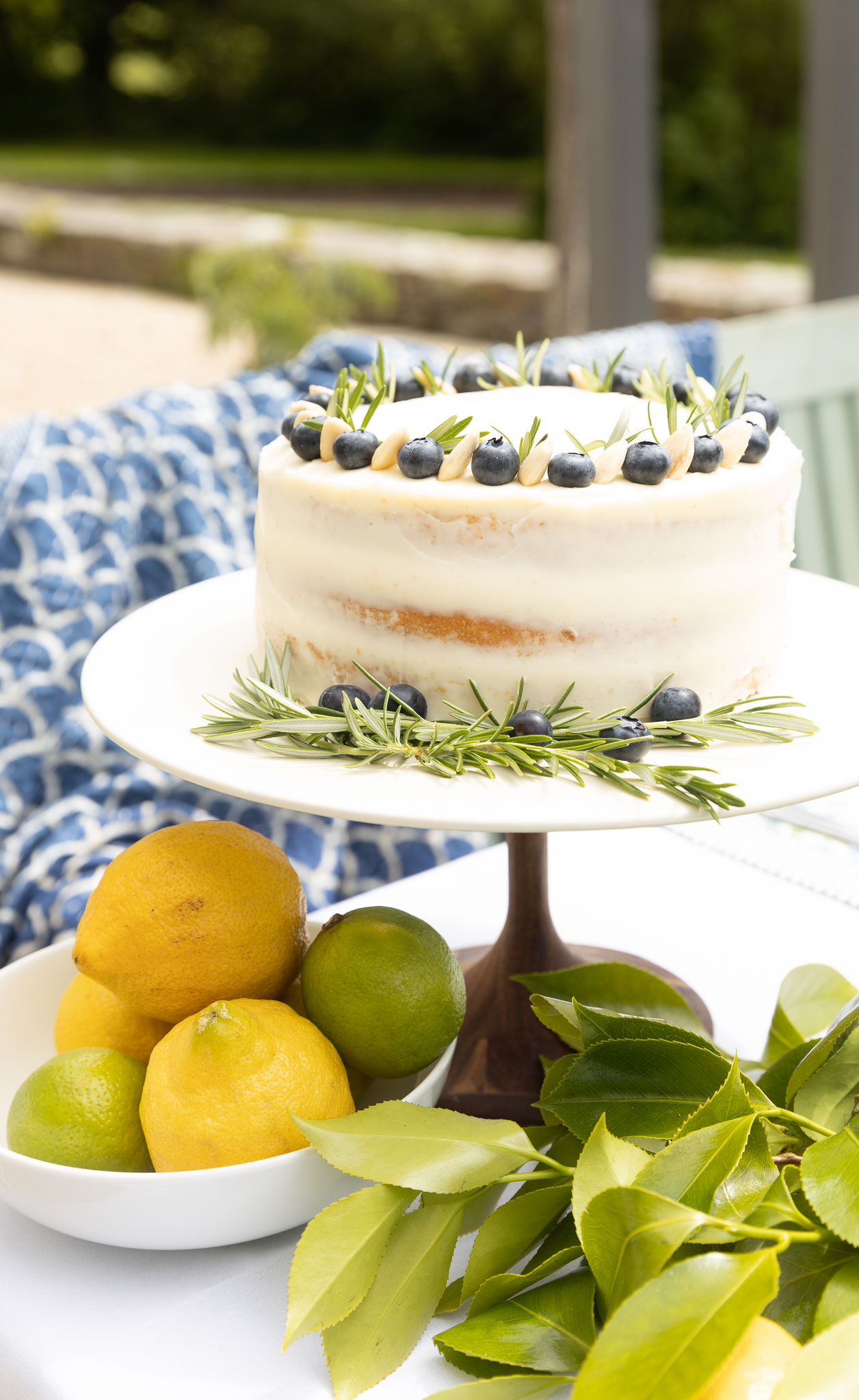 Lemon Curd Naked Sponge Cake on a plate outside.