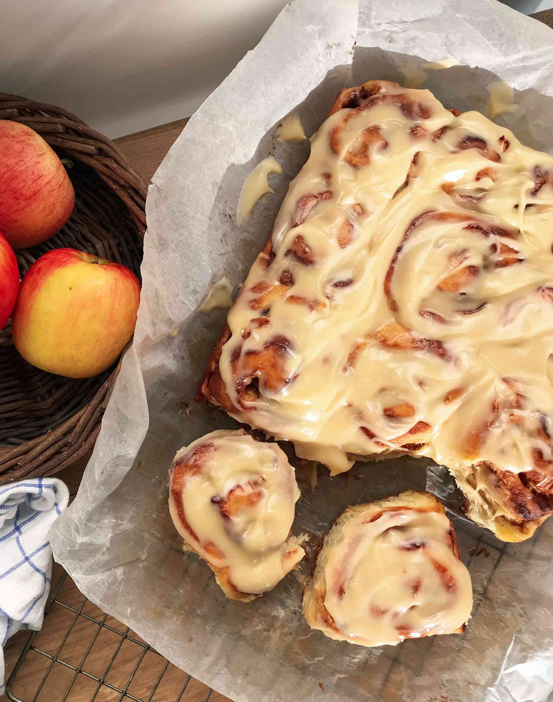 Apple cinnamon rolls on a rack.