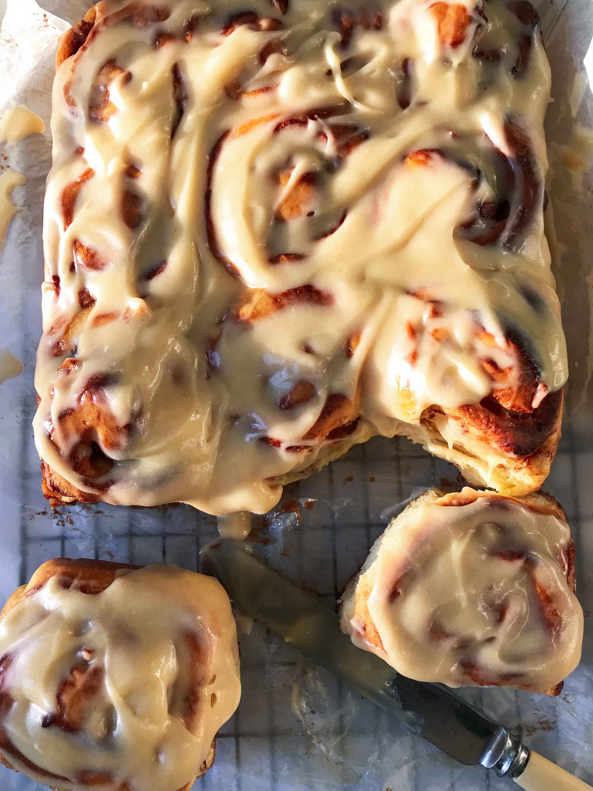 Apple cinnamon rolls on a rack.