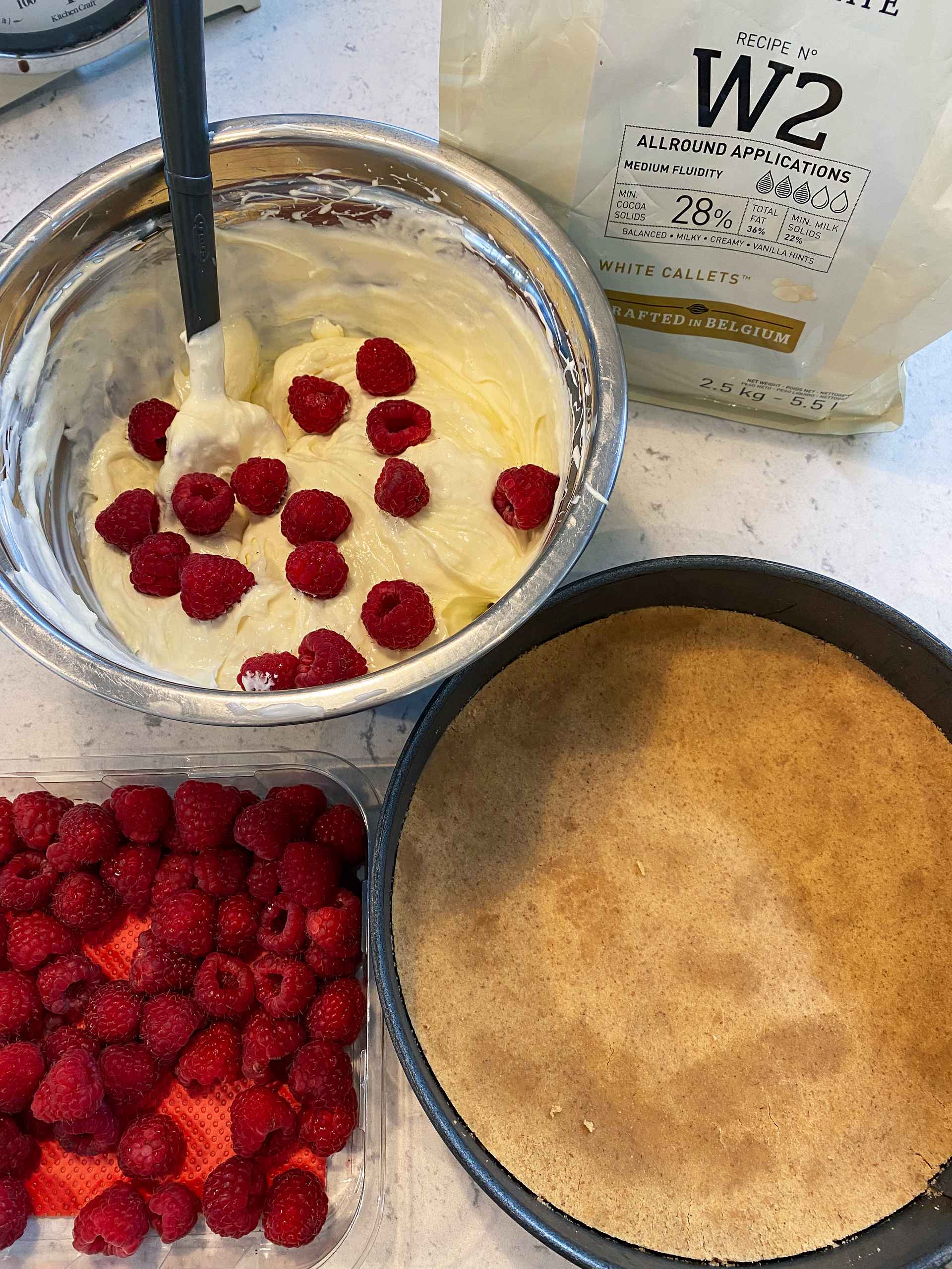 White Chocolate and Raspberry Cheesecake being made.