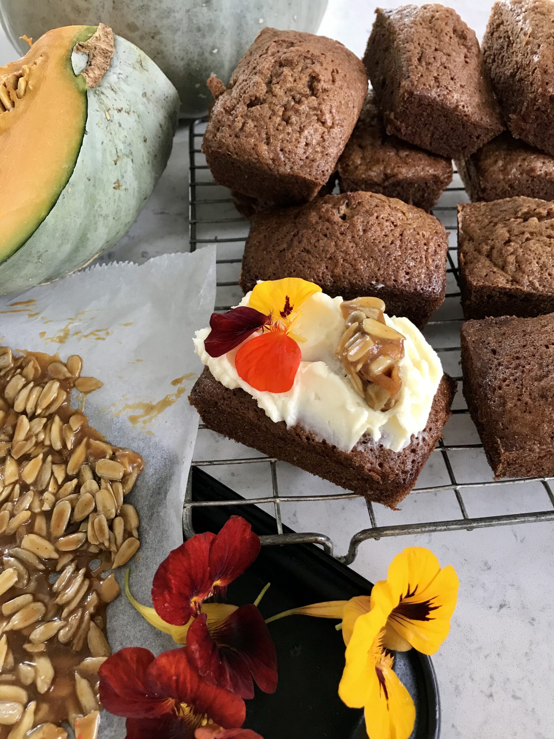 Pumpkin brownies on a rack on a kitchen countertop.