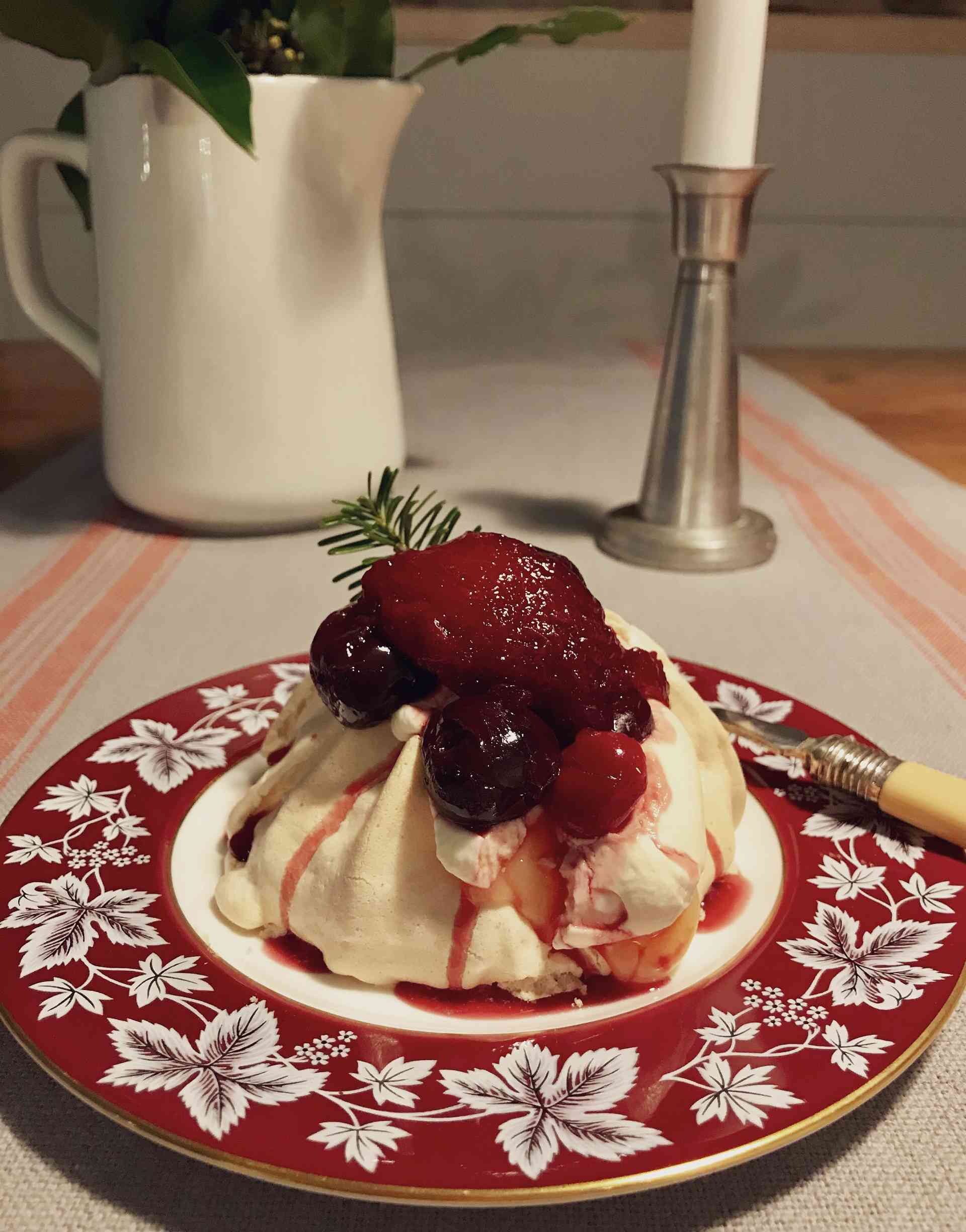 Mulled Fruit Pavlova on a plate on a wooden table.
