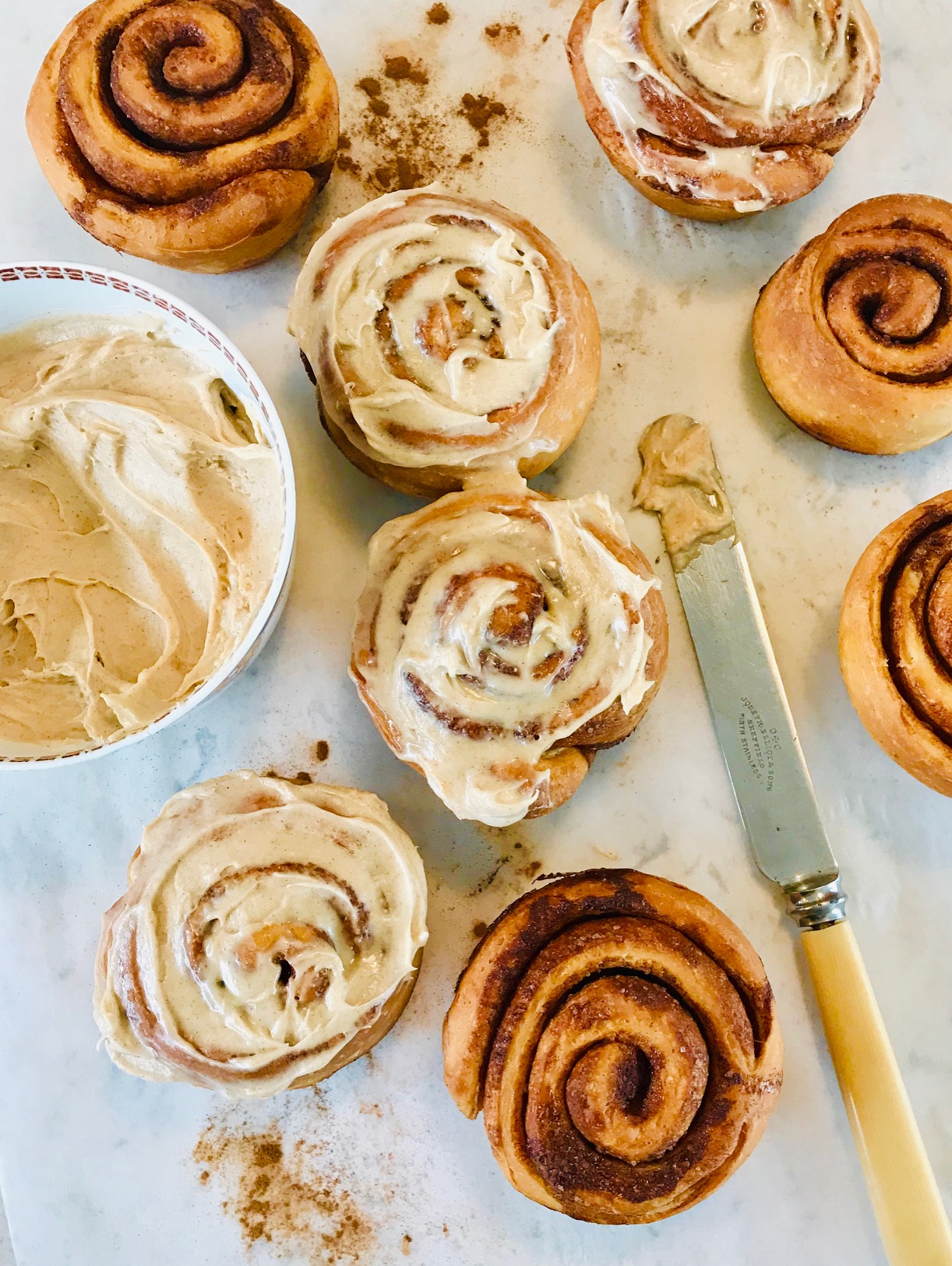Cinnamon Rolls being made on a kitchen countertop.