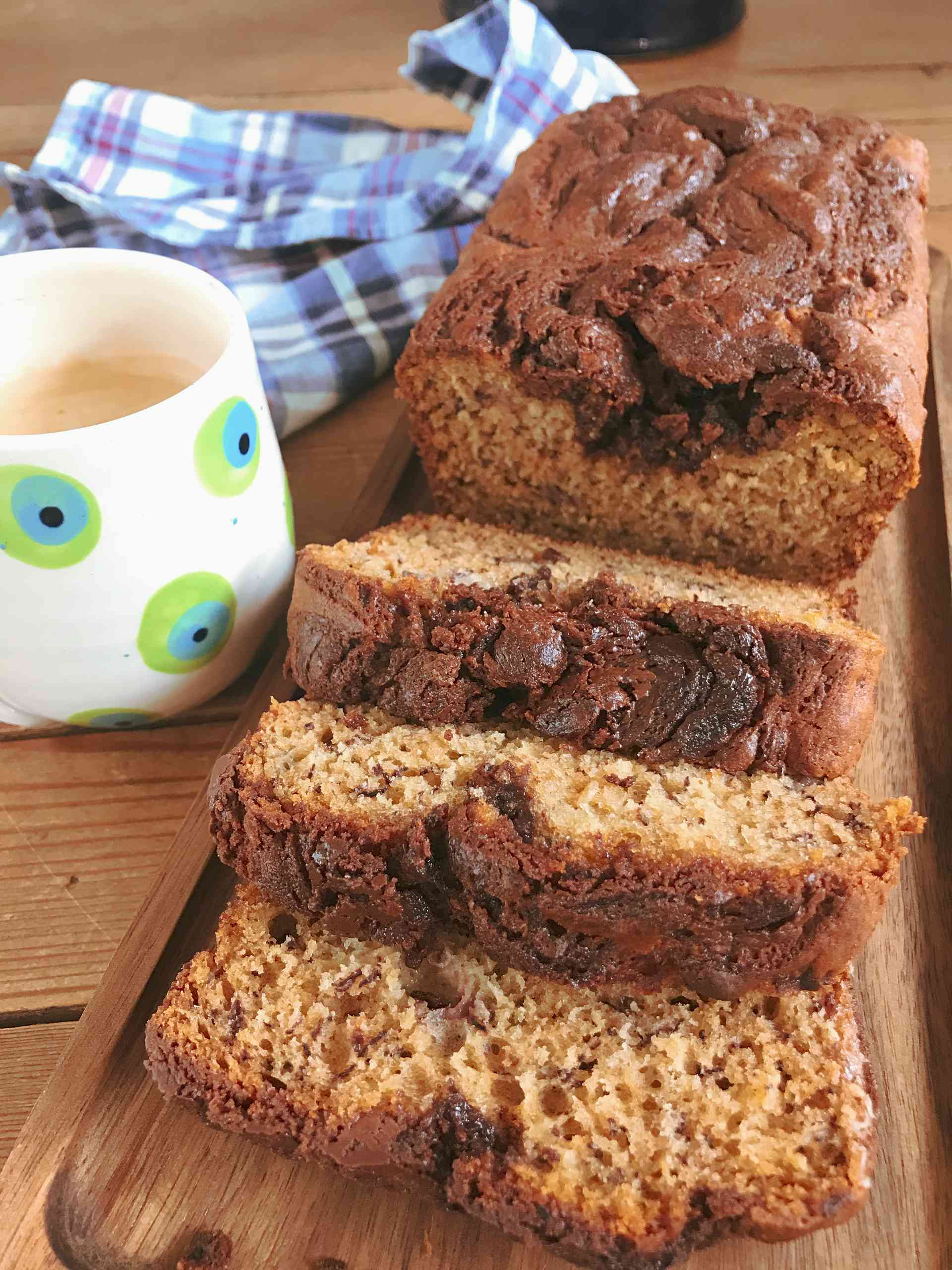 Banana and Nutella swirl bread on a wooden plank.