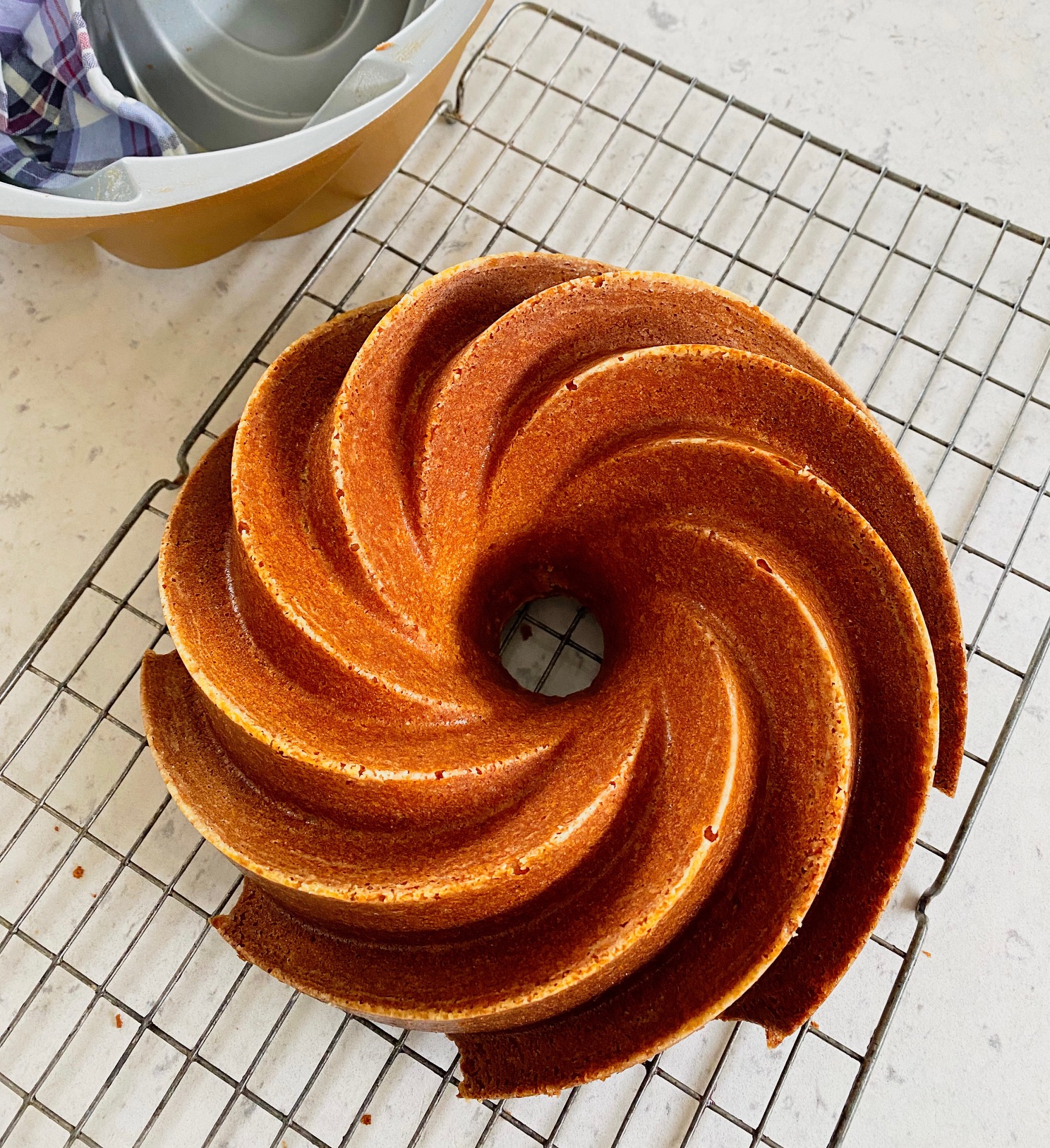 Orange and Cardamon Bundt Cake on a rack.
