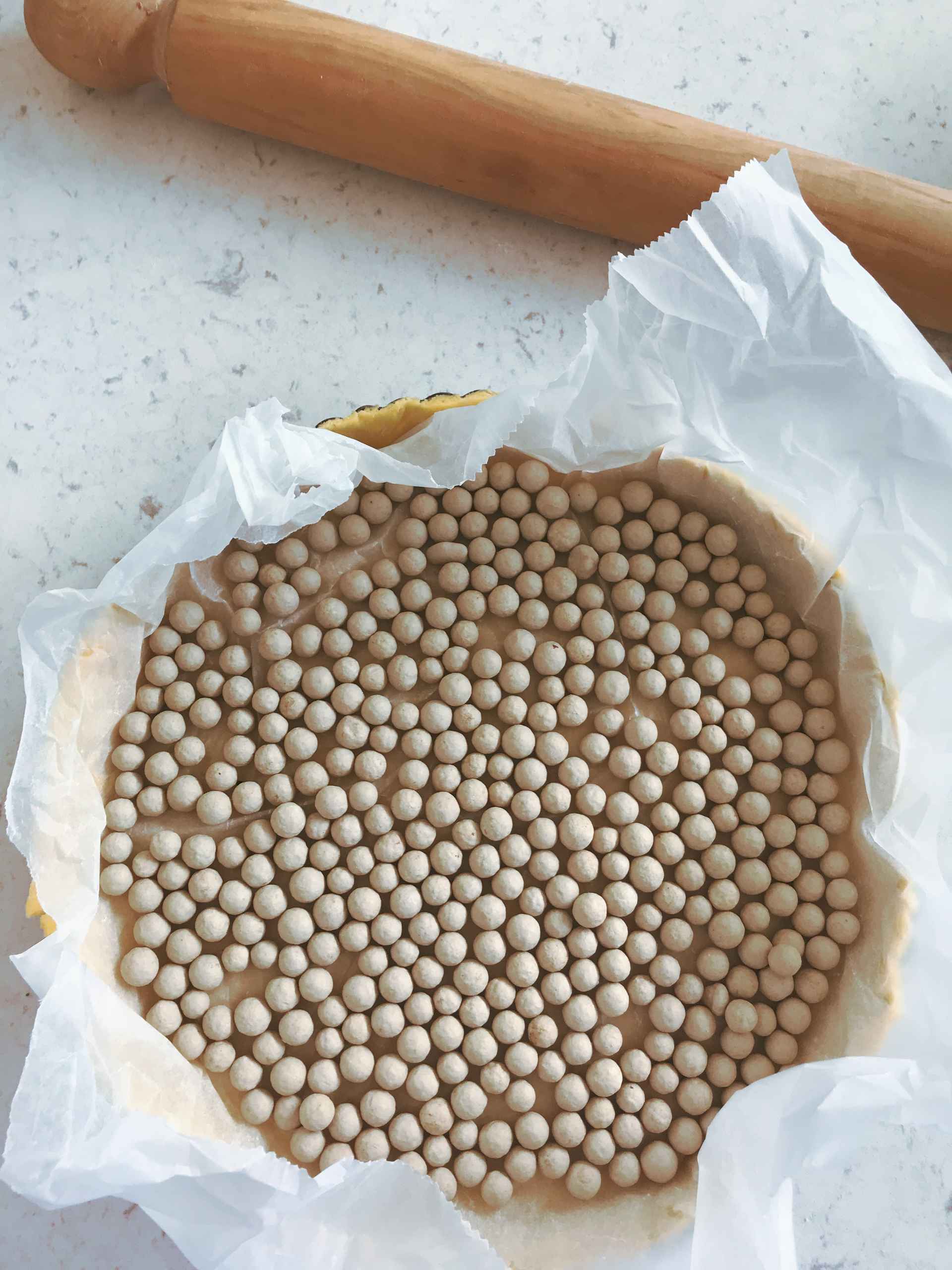 Cake pan filled with dough balls on a kitchen countertop.