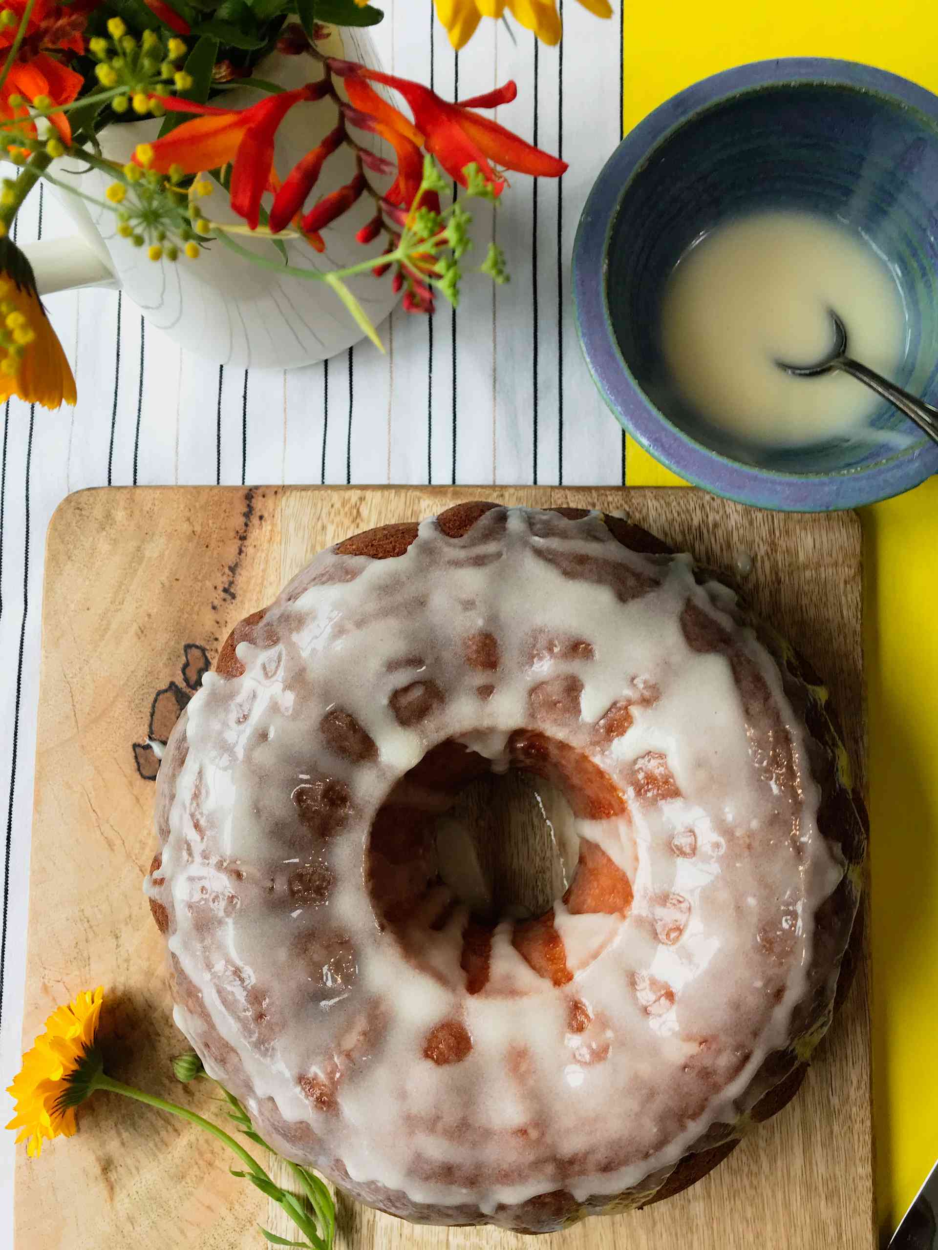 Zesty Lemon Bundt Cake on a wooden plate glazed.