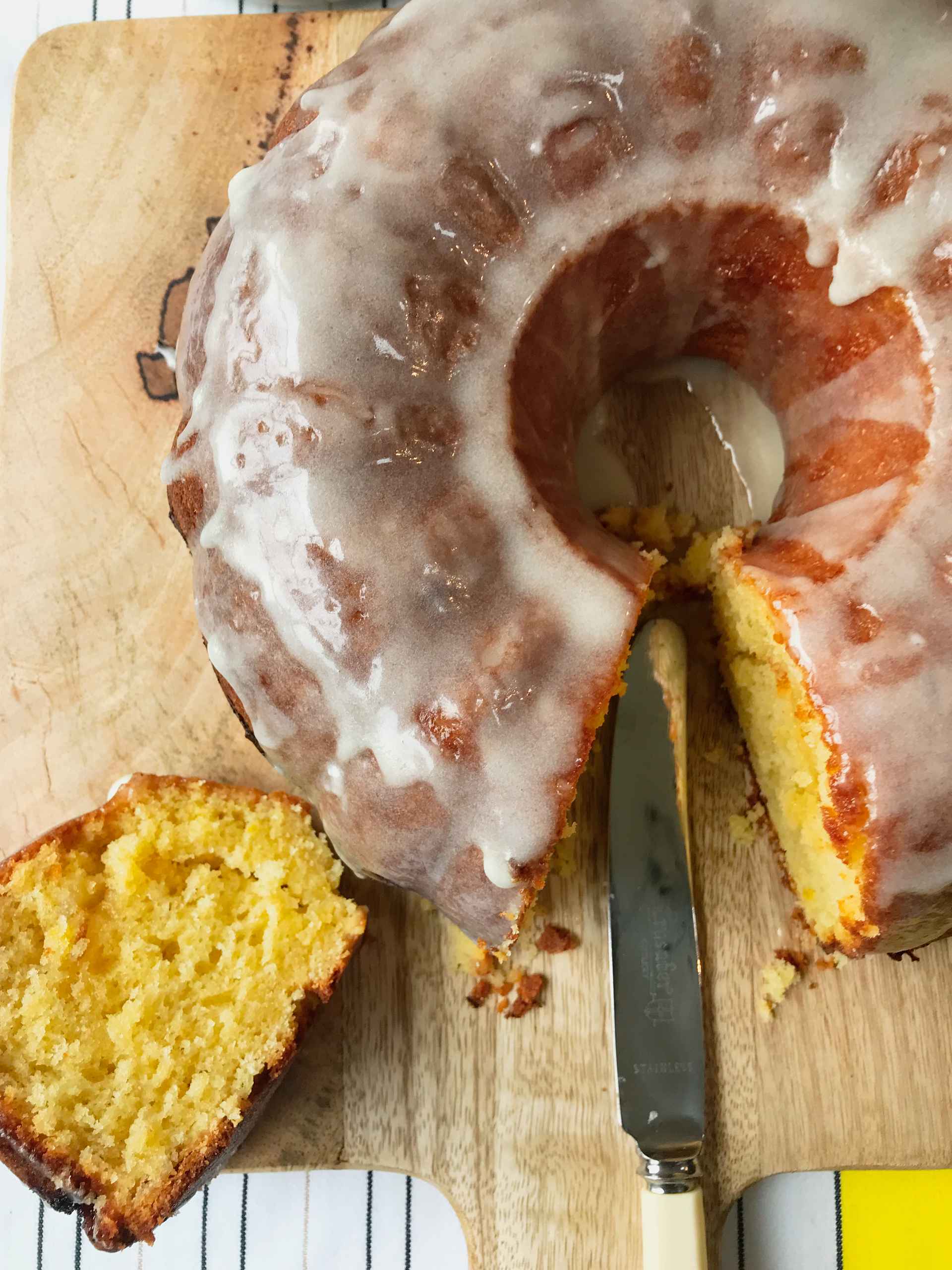 Zesty lemon bundt cake on a wooden plate.