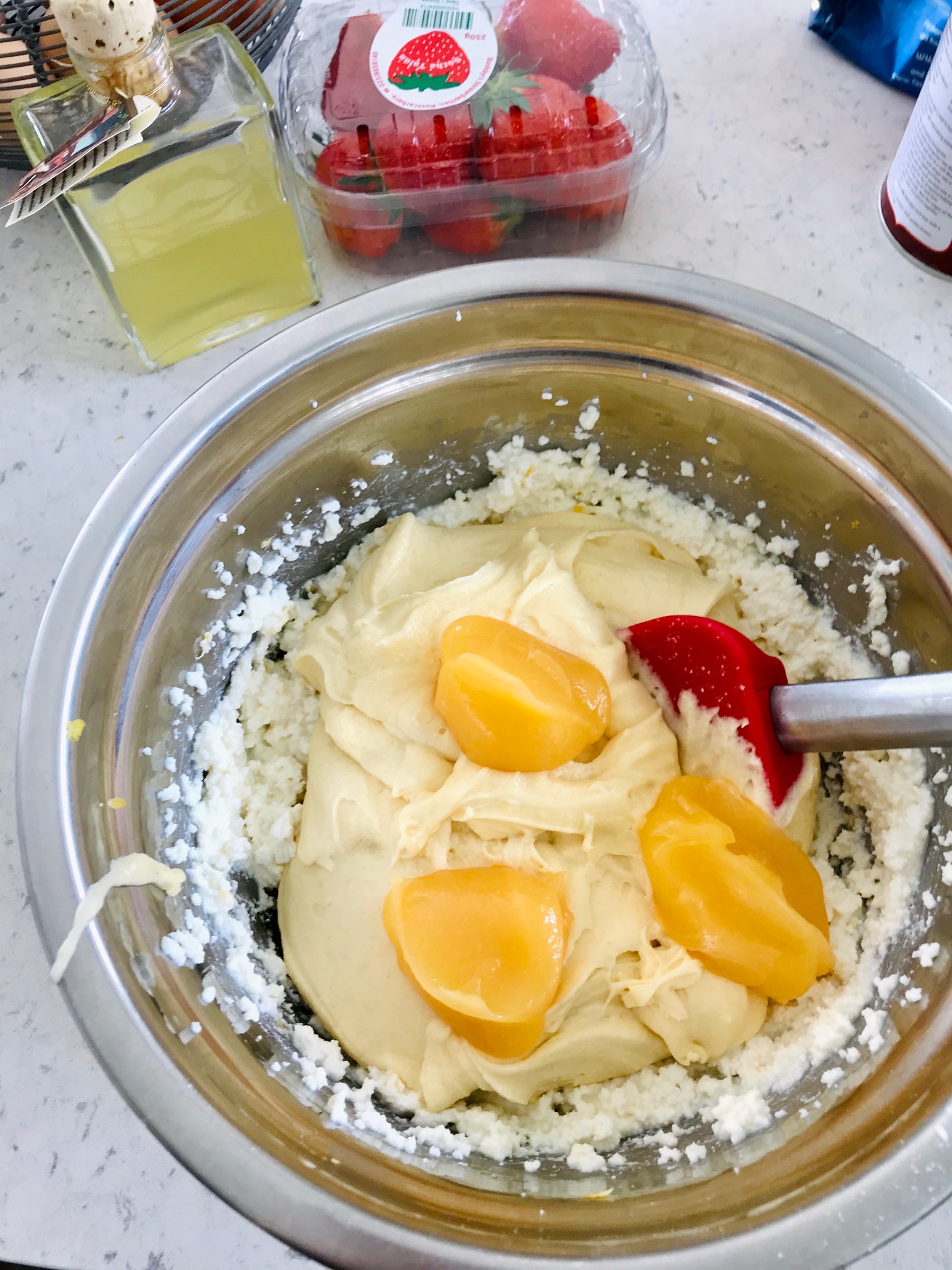 Limoncello Ricotta Cake being made on a kitchen countertop.