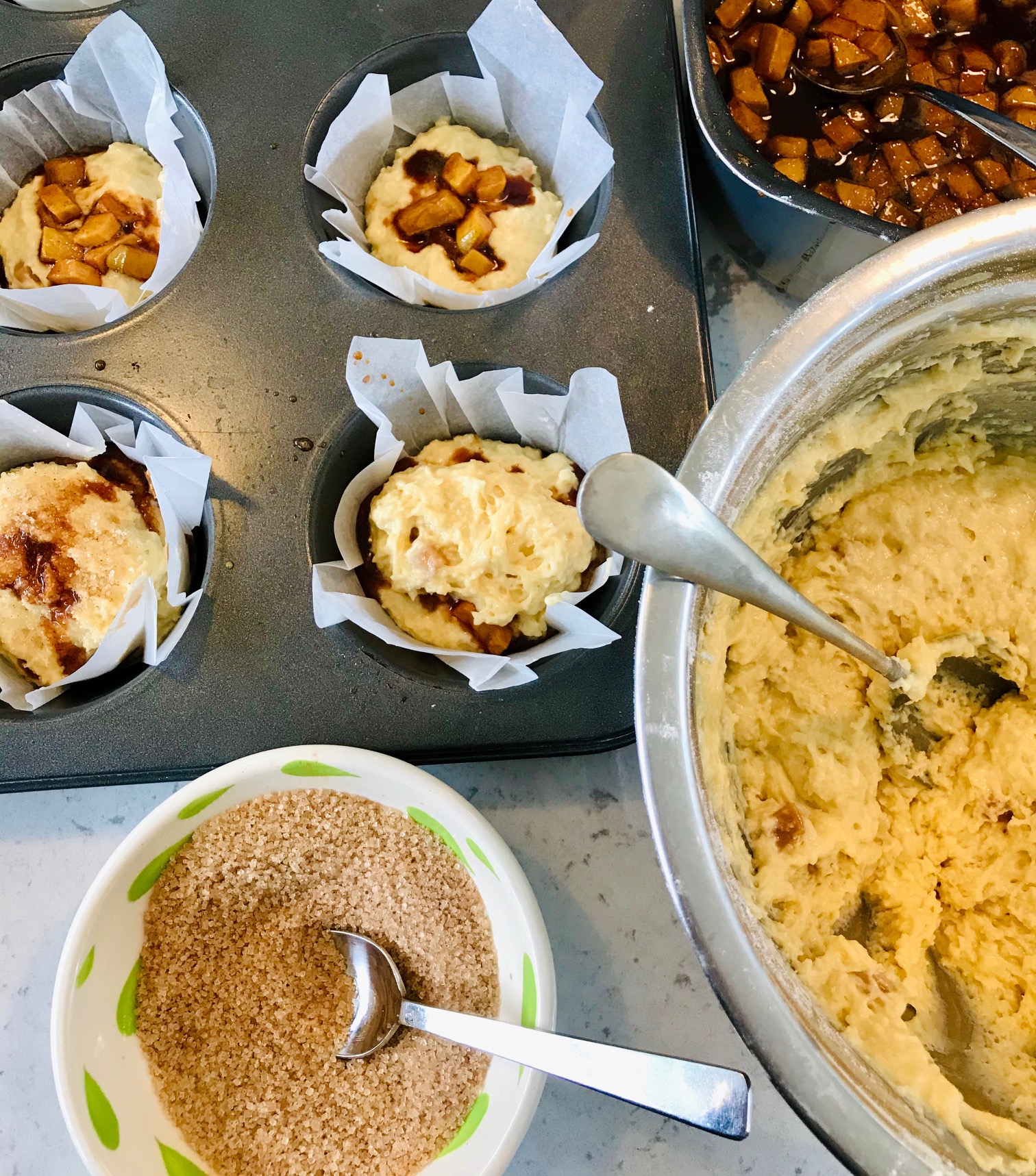 Toffee apple cinnamon muffins in a muffin tin.