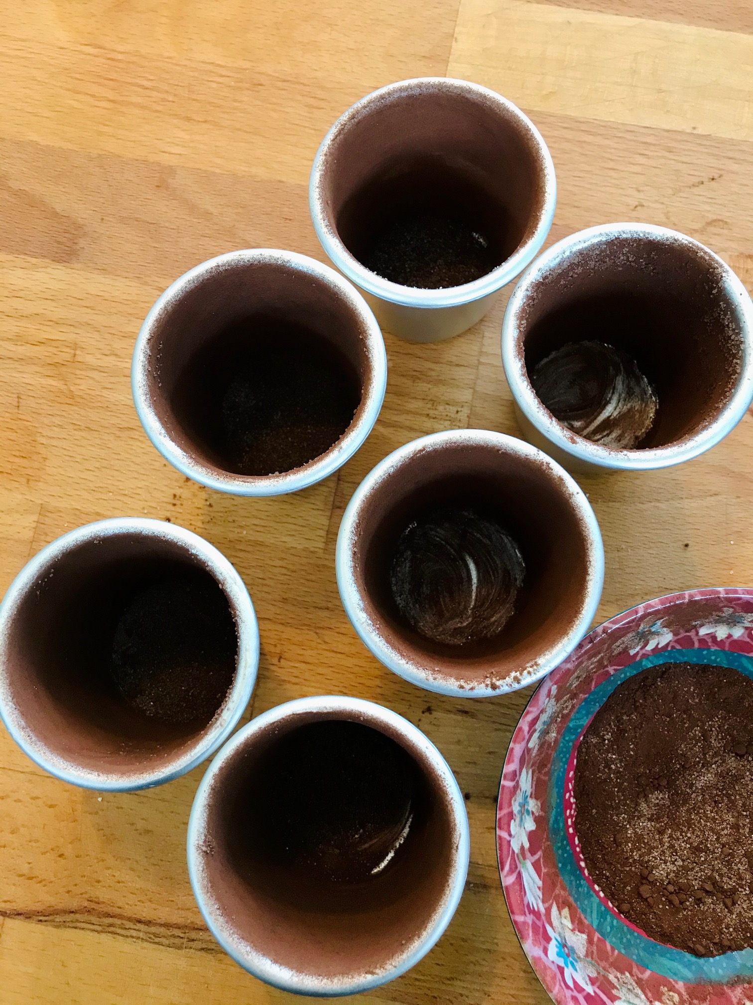 Melting chocolate fondants on a wooden table.