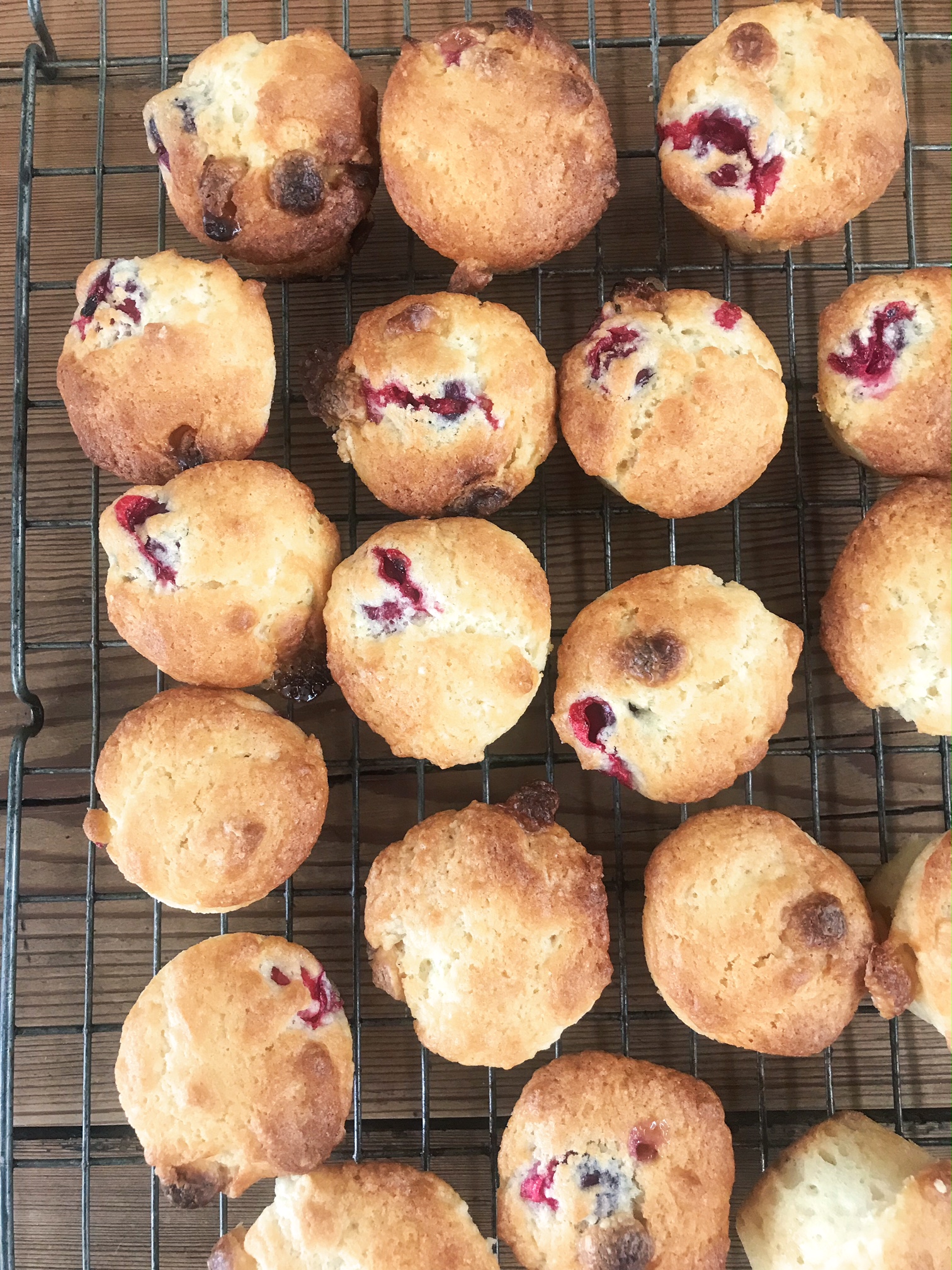 Cranberry & White Chocolate Muffins on a rack.