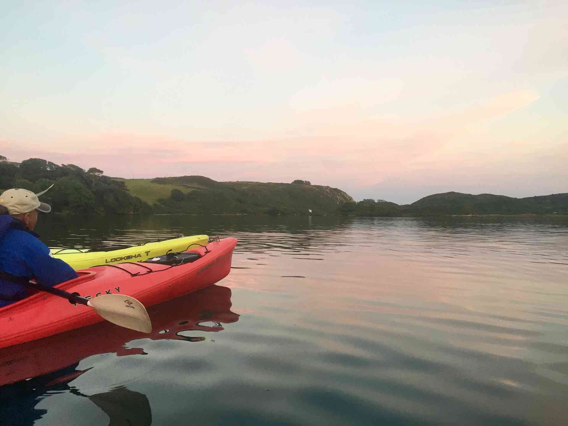Canoes on a lake with sundown.