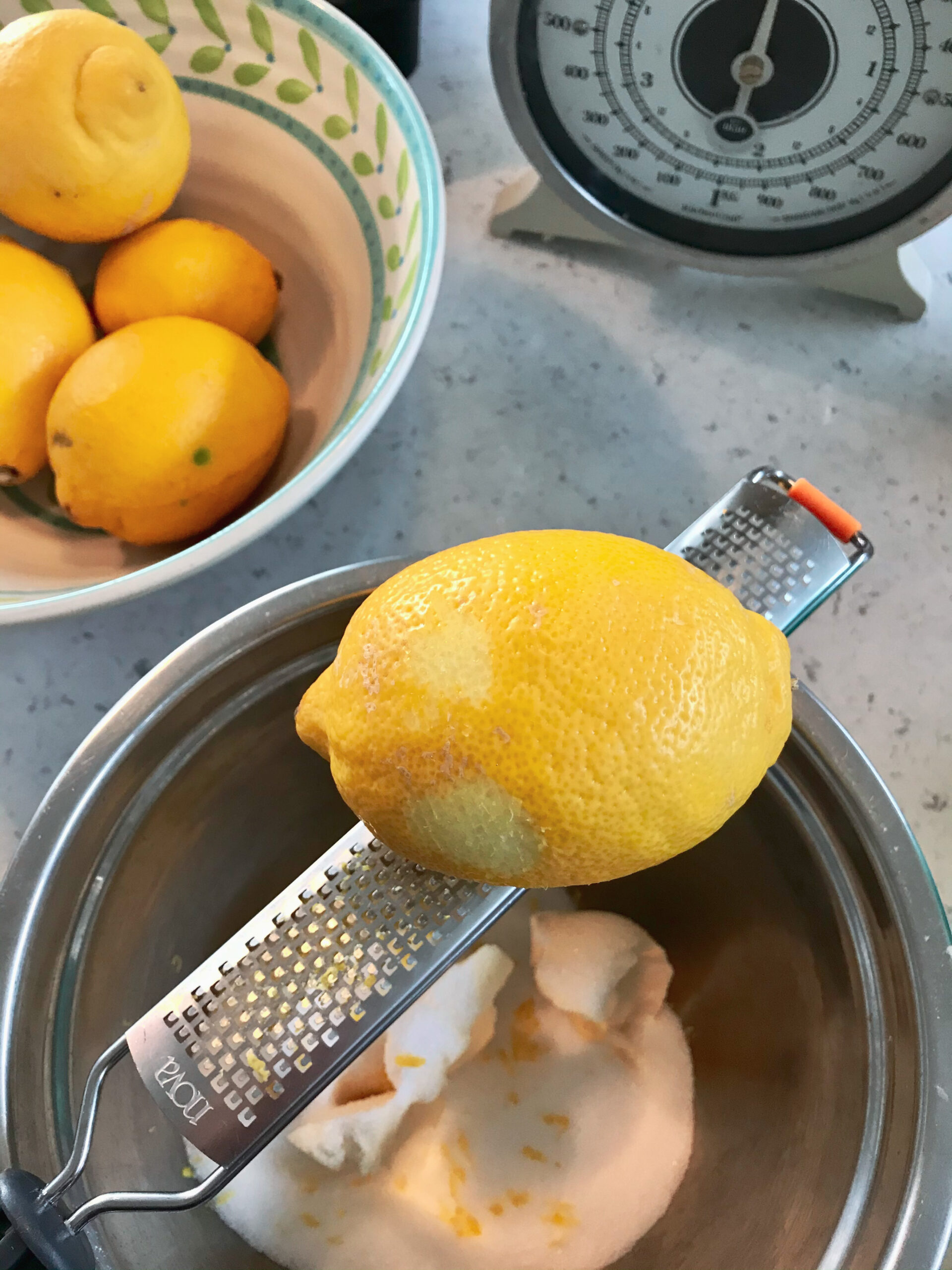 Lemon getting scraped into a bowl.