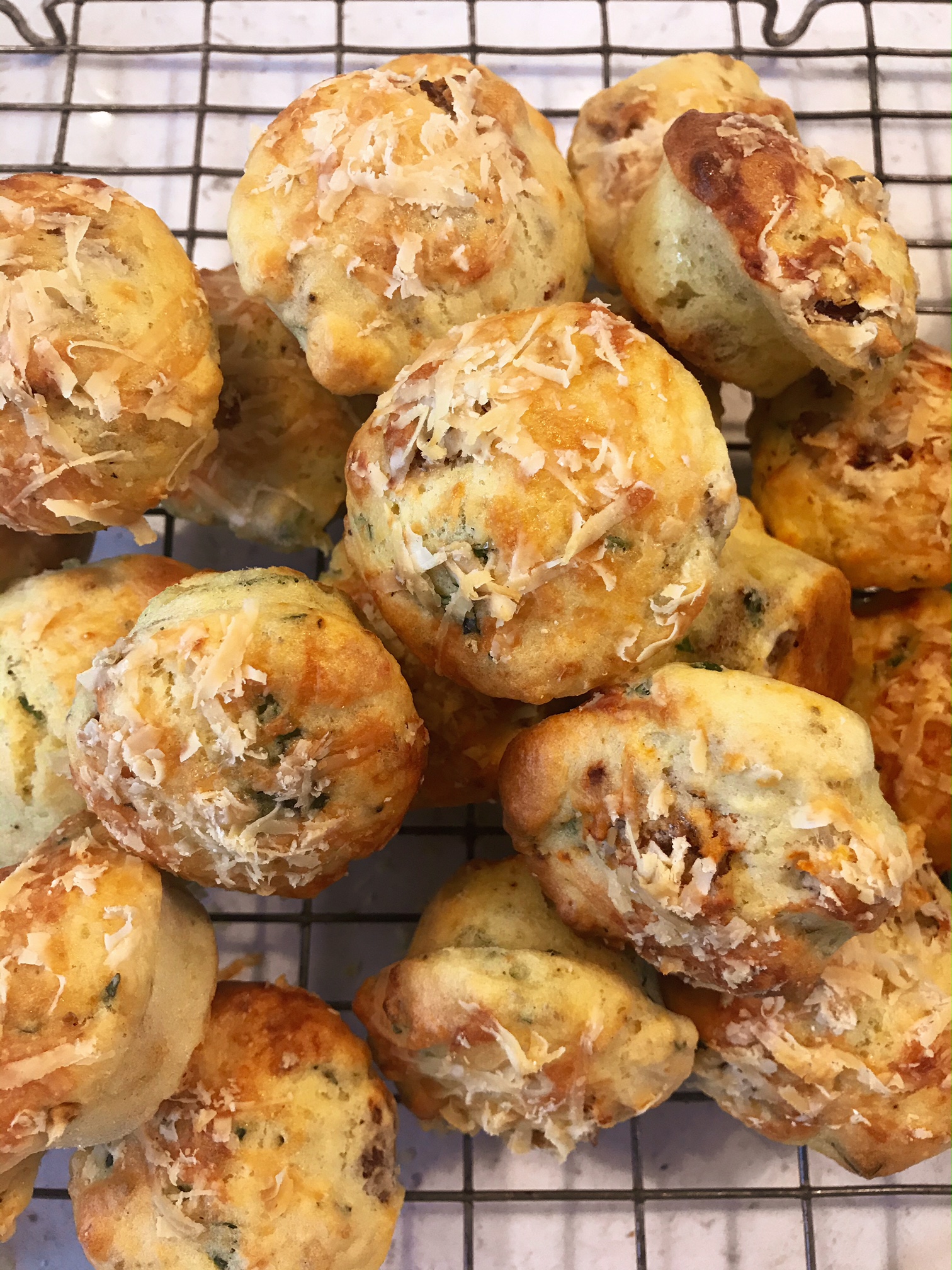Savoury muffins stacked on top of each other on a rack.