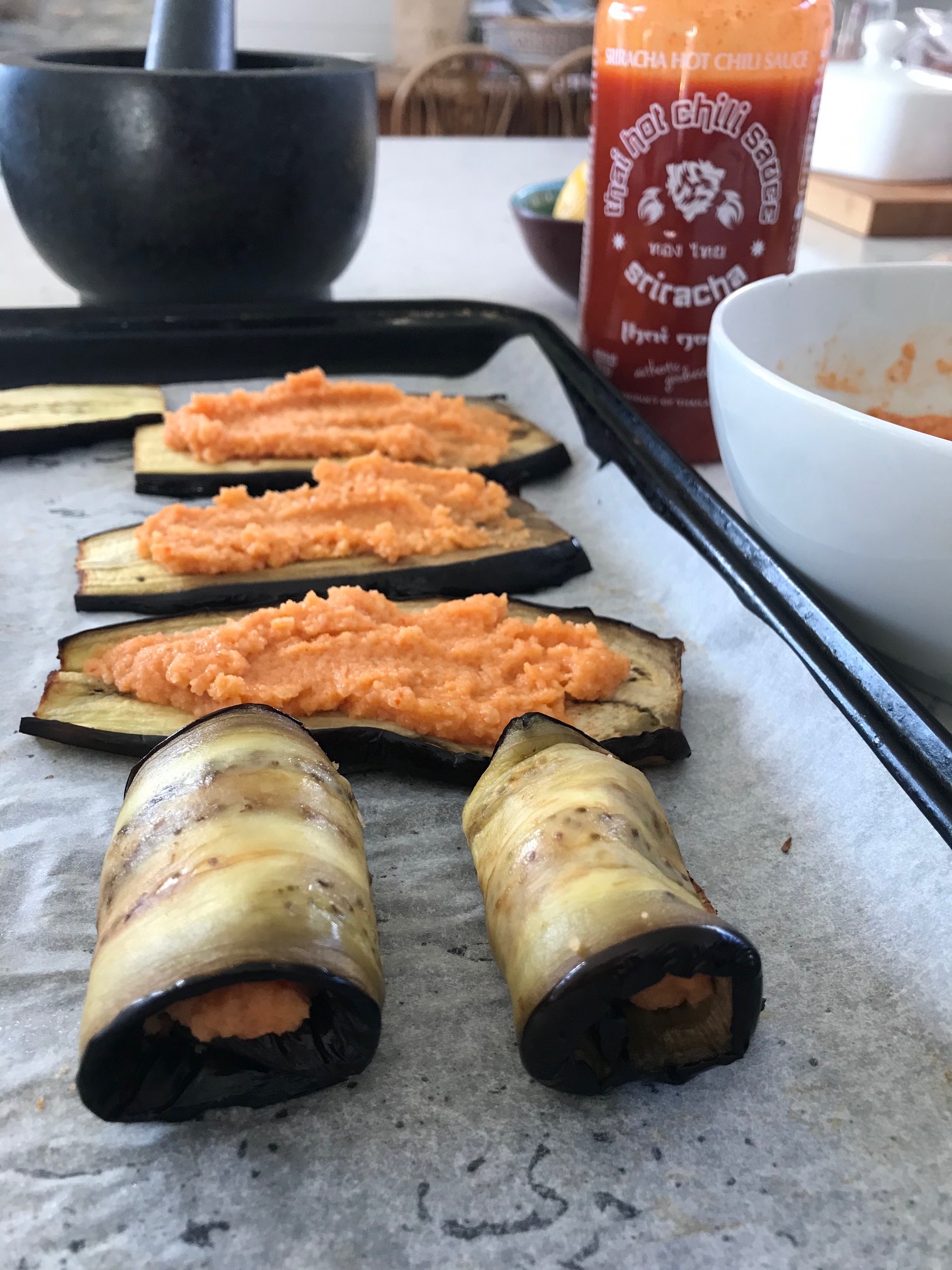 Mince Aubergine rolls on a plate.