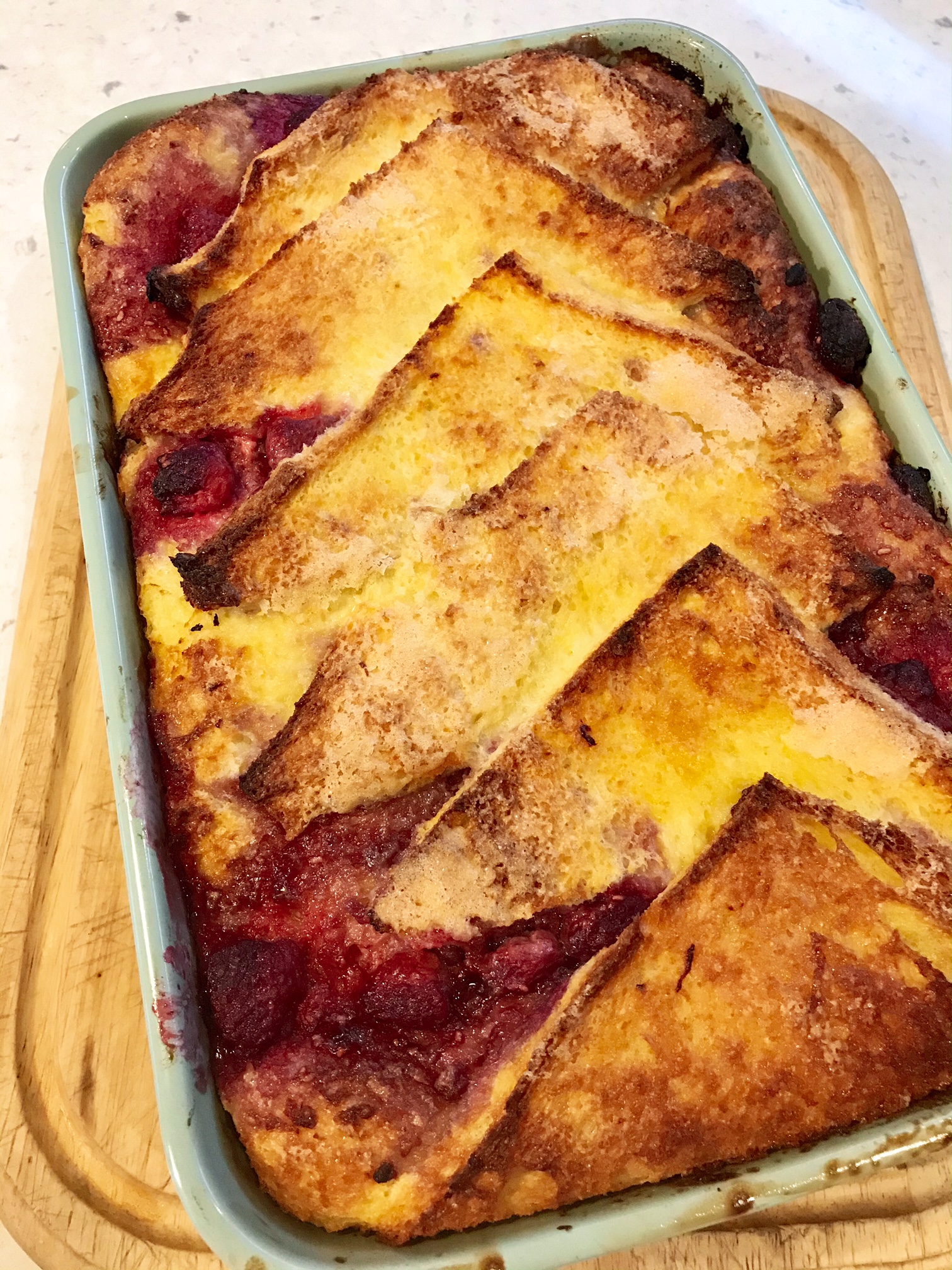 Baked Raspberry Bread in a baking dash on a kitchen countertop.