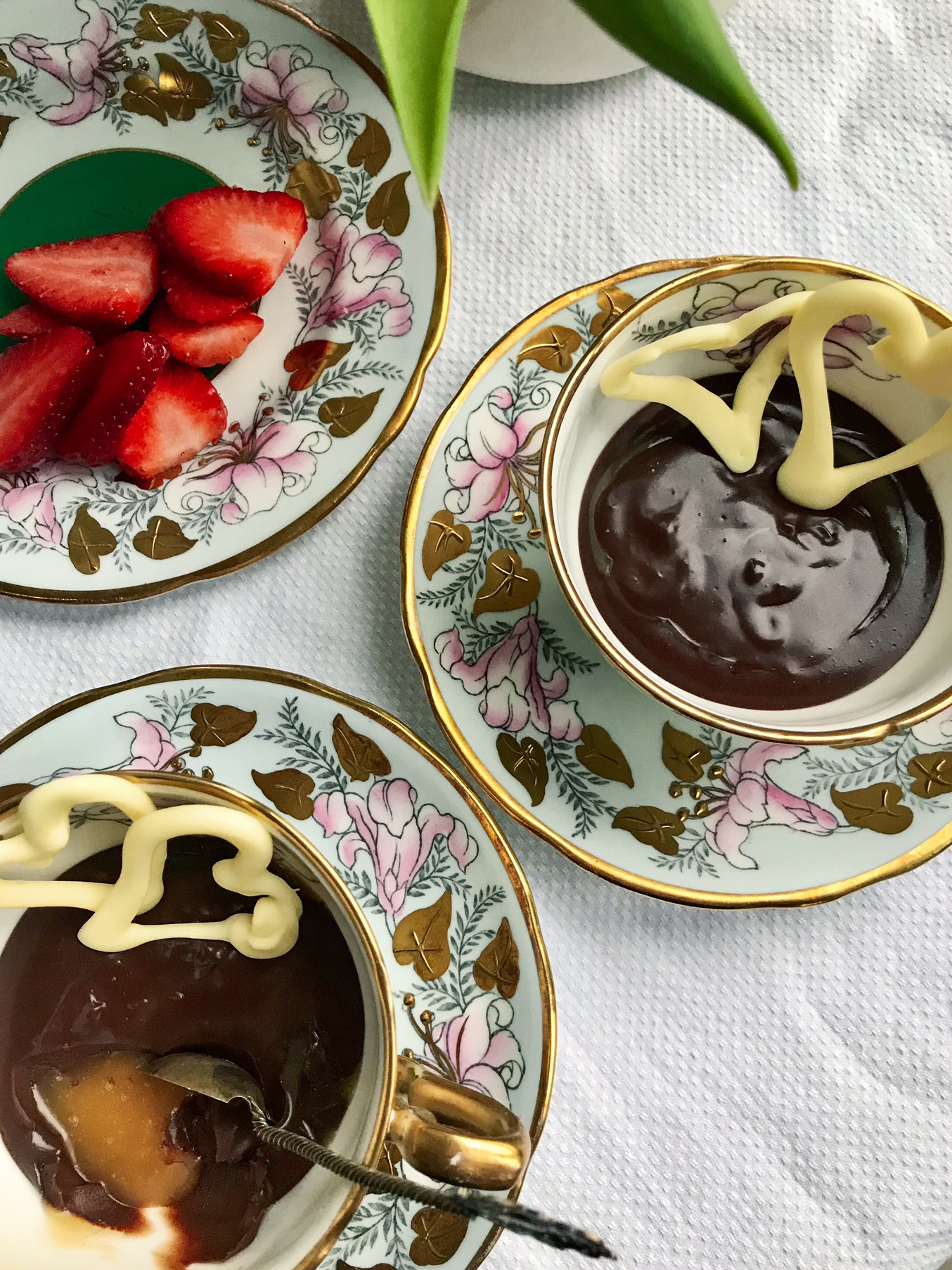 Chocolate dessert with white chocolate hearts on a table.