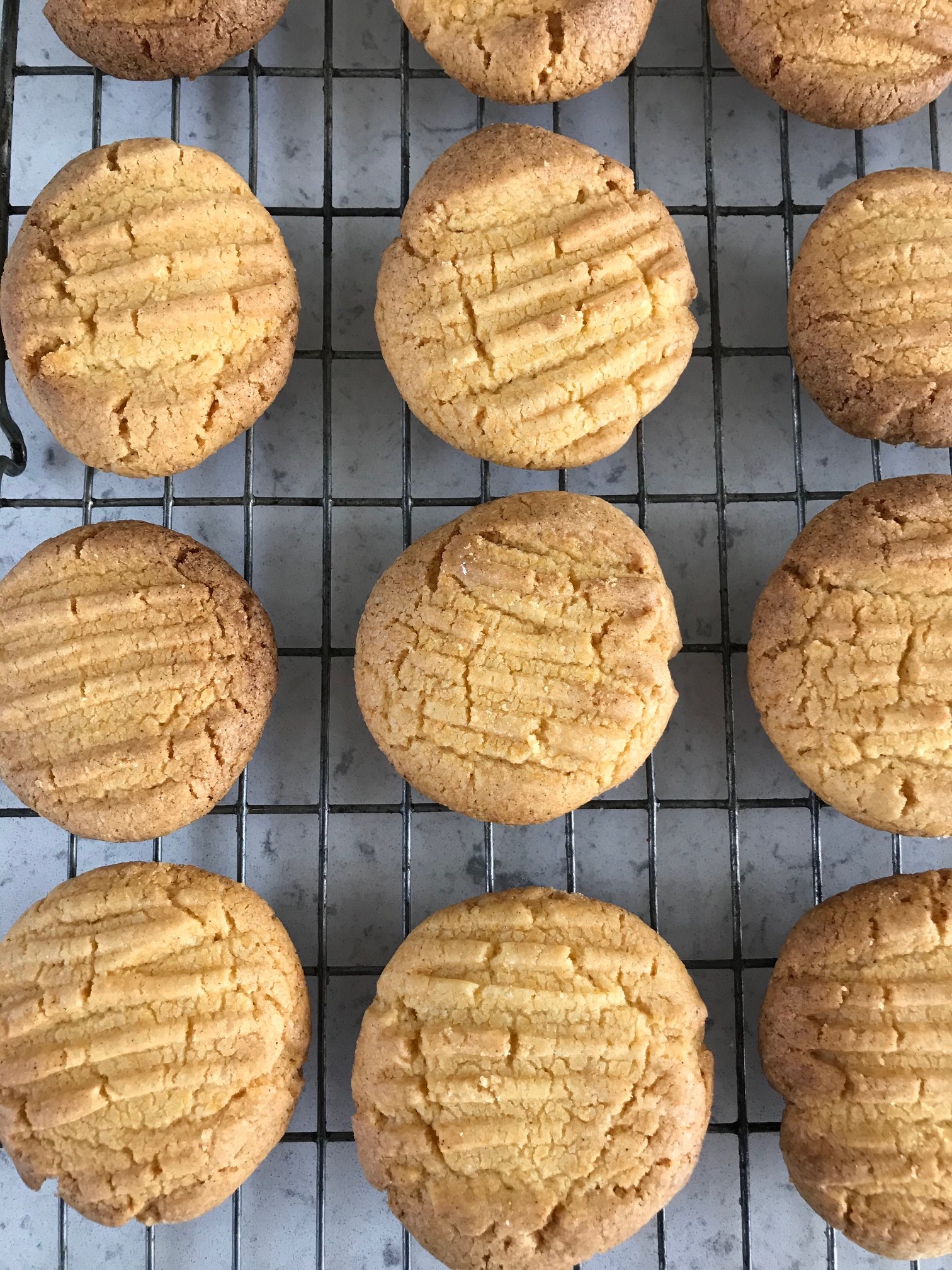 Light brown cookies on a rack.