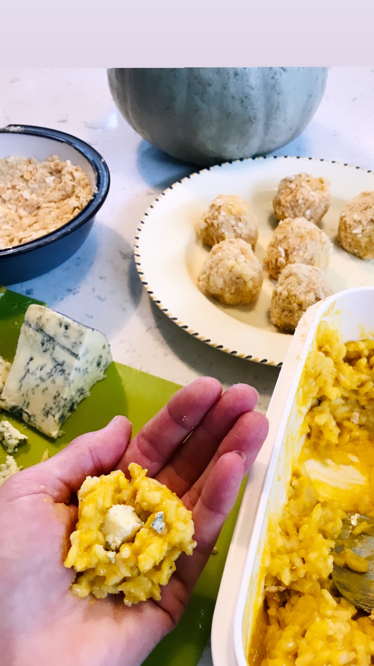 Pumpkin balls being made in someones hand.