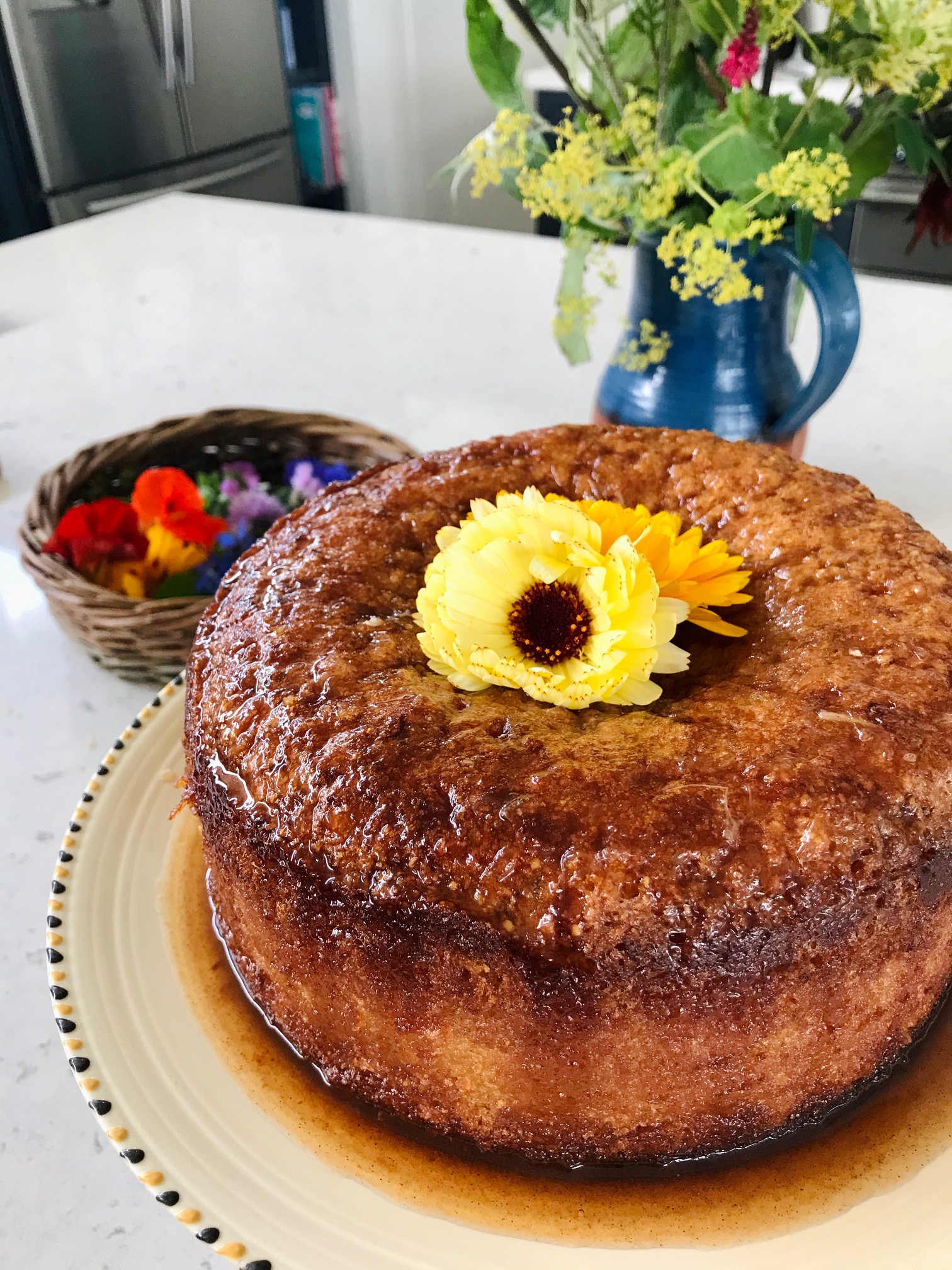 Orange and marigold cake on a kitchen countertop.