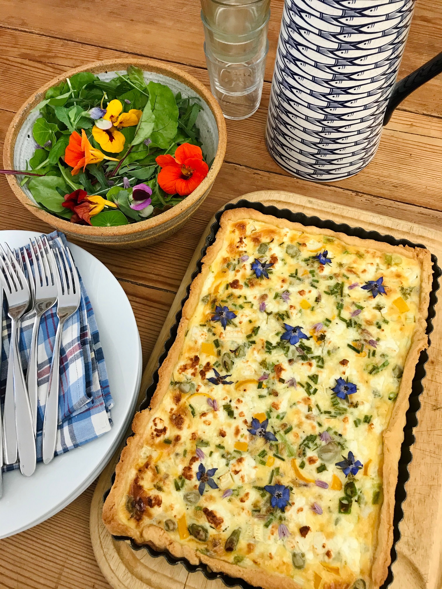 Orange and marigold flourless cake on a wooden table.