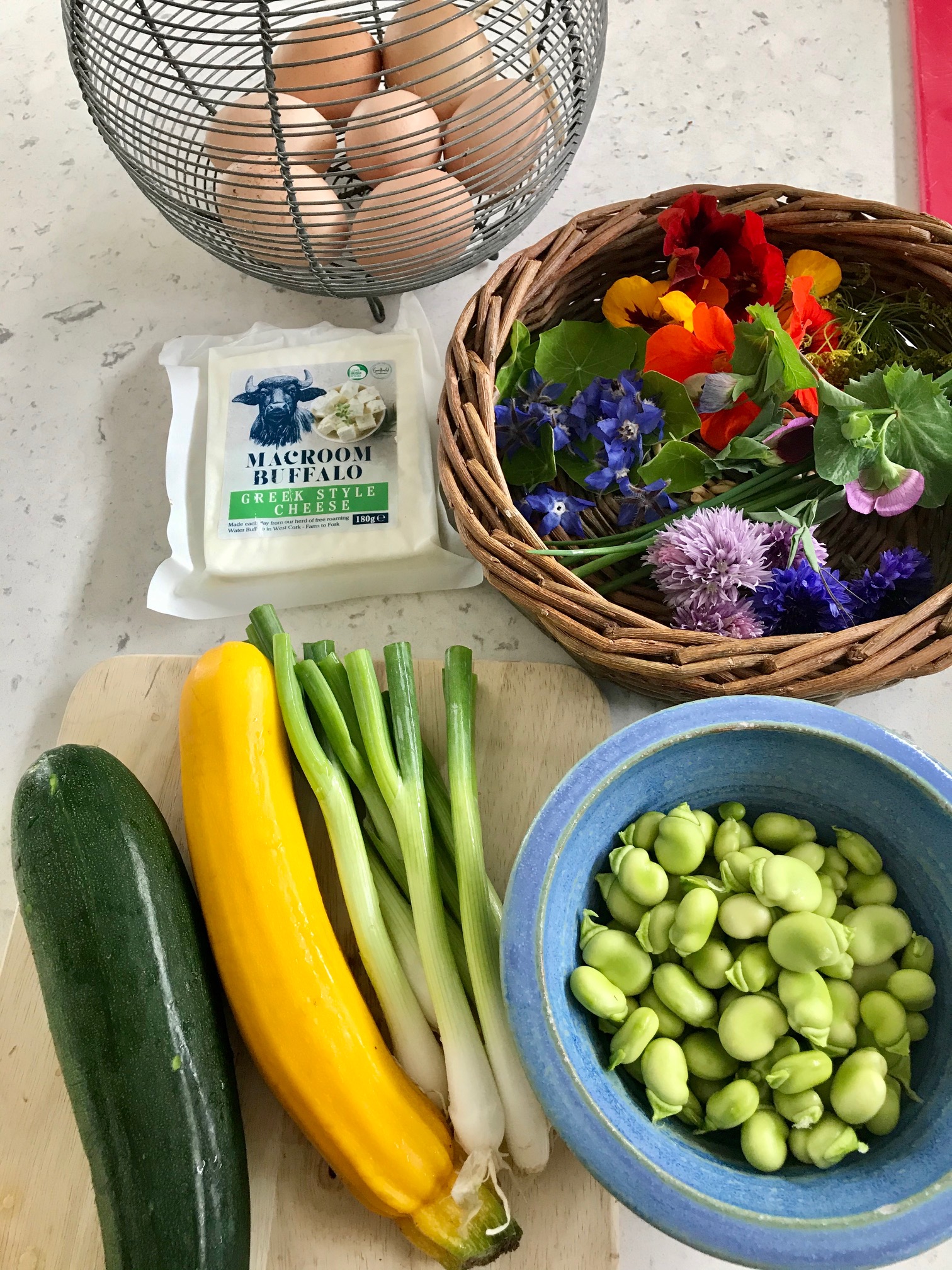 Orange and marigold ingredients on a kitchen countertop.